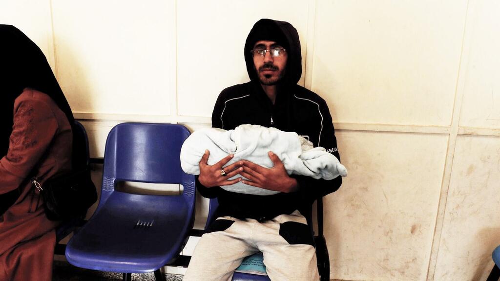 محمد عرب، نازح فلسطيني جاء إلى مركز النصيرات الصحي التابع للأونروا من أجل الحصول على التطعيم لطفله.